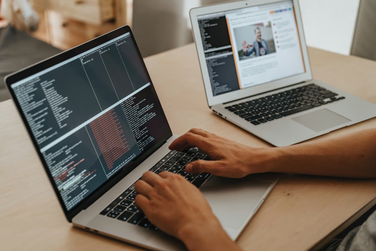 Person Coding on Macbook Pro